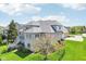 Elegant two-story home with a well-manicured lawn, attached garage, and beautiful landscaping creating an inviting curb appeal at 476 Sapphire Dr, Carmel, IN 46032