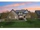 Charming two-story home with manicured lawn, mature trees, and neutral colored brick giving it a timeless appeal at 476 Sapphire Dr, Carmel, IN 46032