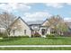 Inviting two-story brick home with manicured lawn, mature trees, and charming landscaping at 476 Sapphire Dr, Carmel, IN 46032