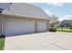 Wide driveway leading to a two-car garage, with lawn in the background at 476 Sapphire Dr, Carmel, IN 46032