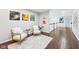 Inviting upstairs hallway with seating area featuring art, hardwood floors, and bright lighting at 476 Sapphire Dr, Carmel, IN 46032