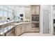 Stylish kitchen featuring stainless steel appliances, granite countertops, and views into the living room at 476 Sapphire Dr, Carmel, IN 46032