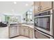 Bright eat-in kitchen features granite countertops, stainless steel appliances, and is open to the living room at 476 Sapphire Dr, Carmel, IN 46032