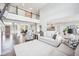 Bright, open-concept living room with hardwood floors, soaring ceilings, and a view of the dining area at 476 Sapphire Dr, Carmel, IN 46032