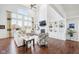 Spacious living room features large windows, fireplace, built-in shelving, and hardwood floors at 476 Sapphire Dr, Carmel, IN 46032