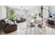 Bright living area with tile floors, a ceiling fan, ample windows, and a comfortable seating arrangement at 476 Sapphire Dr, Carmel, IN 46032