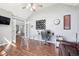 Well-lit home office with a desk, leather sofa, and wood flooring at 476 Sapphire Dr, Carmel, IN 46032