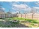 Large backyard with privacy fence, fire pit, string lights, and lush green grass at 504 S Lebanon St, Lebanon, IN 46052