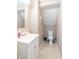 Compact bathroom with a white vanity, sink, toilet, and beige walls at 504 S Lebanon St, Lebanon, IN 46052