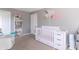 Charming Bedroom with a white crib, bookshelf, and a comfortable armchair at 504 S Lebanon St, Lebanon, IN 46052