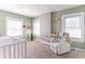 Bright Bedroom with a white crib, armchair, and whimsical wall decorations at 504 S Lebanon St, Lebanon, IN 46052