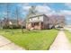 Lovely home showcasing a green lawn, mature trees, and a sidewalk in a quiet residential area at 504 S Lebanon St, Lebanon, IN 46052
