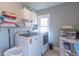 A modern laundry room with white cabinets, shelving, and new washer and dryer units at 504 S Lebanon St, Lebanon, IN 46052