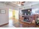 Spacious living room with a brick fireplace, hardwood floors, and an open doorway to another room at 504 S Lebanon St, Lebanon, IN 46052