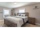 Inviting bedroom with a large wooden bed, nightstands, and natural light from the windows at 504 S Lebanon St, Lebanon, IN 46052
