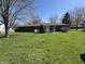 Well maintained backyard, showing the exterior of the house with a good-sized lawn on a sunny day at 508 E Hillside Dr, Anderson, IN 46011
