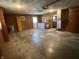 This basement offers painted wood paneling and concrete flooring at 508 E Hillside Dr, Anderson, IN 46011