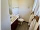 Compact bathroom featuring a single vanity, toilet, and window for natural light at 508 E Hillside Dr, Anderson, IN 46011