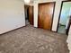 Comfortable bedroom with neutral carpet, closet space, and natural light at 508 E Hillside Dr, Anderson, IN 46011
