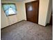 Bedroom featuring neutral carpeting, a closet, and a bright window at 508 E Hillside Dr, Anderson, IN 46011