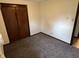 A bedroom features neutral carpeting and a closet for optimal storage at 508 E Hillside Dr, Anderson, IN 46011