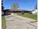 Charming brick home features a two-car garage and a well-maintained lawn at 508 E Hillside Dr, Anderson, IN 46011