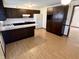 Cozy kitchen with dark cabinetry, white countertops, and breakfast bar area at 508 E Hillside Dr, Anderson, IN 46011