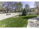Manicured backyard with a white fence and a well-maintained lawn, perfect for outdoor enjoyment at 537 Weyworth Pl, Greenwood, IN 46142
