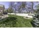 Lush green backyard with a white picket fence and a vibrant lawn, complemented by mature trees at 537 Weyworth Pl, Greenwood, IN 46142