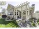 Charming backyard with a pergola-covered patio, grill, and landscaped garden, ideal for serene outdoor living at 537 Weyworth Pl, Greenwood, IN 46142