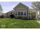 Spacious backyard patio featuring a pergola, grill, seating and manicured lawn, great for outdoor activities at 537 Weyworth Pl, Greenwood, IN 46142