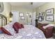 Bedroom with a bed decorated with floral red and white bedding and neutral paint at 537 Weyworth Pl, Greenwood, IN 46142