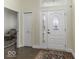 Inviting foyer with hardwood floors, decorative front door, and view into a sitting room, creating a warm and welcoming entrance at 537 Weyworth Pl, Greenwood, IN 46142