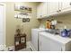 Cozy laundry room with front loading washer and dryer and painted cabinets at 537 Weyworth Pl, Greenwood, IN 46142