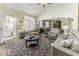 Bright living room featuring vaulted ceilings, comfortable seating, and large windows that create an inviting and airy atmosphere at 537 Weyworth Pl, Greenwood, IN 46142