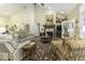 Spacious living room with vaulted ceilings, plush seating, a fireplace, and large windows providing natural light and warmth at 537 Weyworth Pl, Greenwood, IN 46142