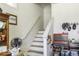 View of the stairwell with white stairs, a craftsman toolbox, and a wooden display cabinet at 537 Weyworth Pl, Greenwood, IN 46142