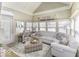 Bright sunroom with white vaulted ceilings and large windows, featuring a plush sectional sofa at 537 Weyworth Pl, Greenwood, IN 46142