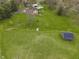 Aerial view of home and grounds, featuring a creek, bridge, outbuildings, and large manicured lawn at 5455 S 800 E, Zionsville, IN 46077