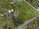 Aerial shot highlighting a spacious lot, in-ground pool, long driveway, and well-maintained landscaping at 5455 S 800 E, Zionsville, IN 46077
