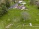 Aerial view showcasing home with large lawn, creek, long driveway, pool, and outbuildings at 5455 S 800 E, Zionsville, IN 46077