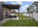 Charming backyard with a covered patio, stone walkway, lush green lawn, and privacy fencing at 5455 S 800 E, Zionsville, IN 46077