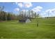 Scenic view of a rustic barn nestled in a lush green field with trees in the background, embodying country charm at 5455 S 800 E, Zionsville, IN 46077