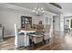 A dining room with a wood table, wicker chairs, and a modern chandelier creates a warm and inviting space at 5455 S 800 E, Zionsville, IN 46077