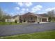 Inviting single-story home with a three-car garage, stone chimney, cozy porch, and a spacious asphalt driveway at 5455 S 800 E, Zionsville, IN 46077