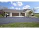 Attractive angle showing a house with a three-car garage, a small porch with furniture, and well-maintained landscaping at 5455 S 800 E, Zionsville, IN 46077