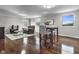 The living room has hardwood floors, lots of seating, and natural light from windows and a glass door at 5455 S 800 E, Zionsville, IN 46077
