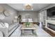 A living room featuring a wooden coffee table, decorative wall art, sliding barn doors, and a stone fireplace at 5455 S 800 E, Zionsville, IN 46077