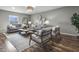 A living room with couches, wood floors, decorative woven wall hangings, and a textured rug creates a cozy space at 5455 S 800 E, Zionsville, IN 46077