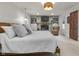 Main bedroom featuring a modern stone fireplace, built-in cabinets, a woven light fixture, and carpet at 5455 S 800 E, Zionsville, IN 46077